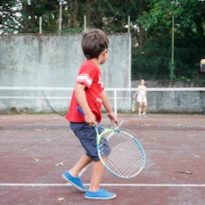 Boy playing tennis with his mother, Oleiros, A Coruna, Galicia, Spain
