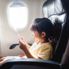 A child sits in the window seat of an airplane. New federal guidelines protect parents from having t...